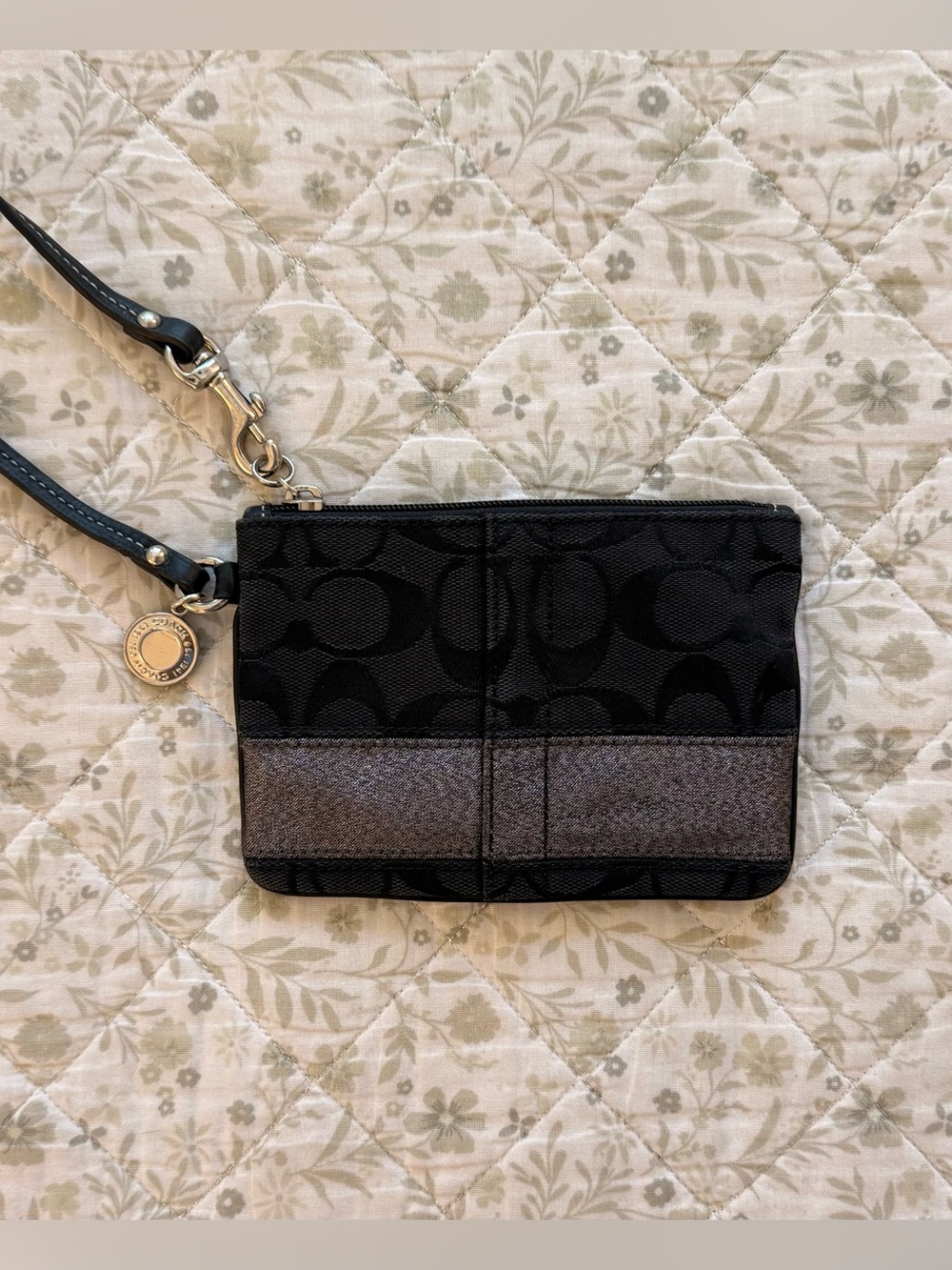 Vintage Coach black monogram wristlet with shimmery silver stripe detail